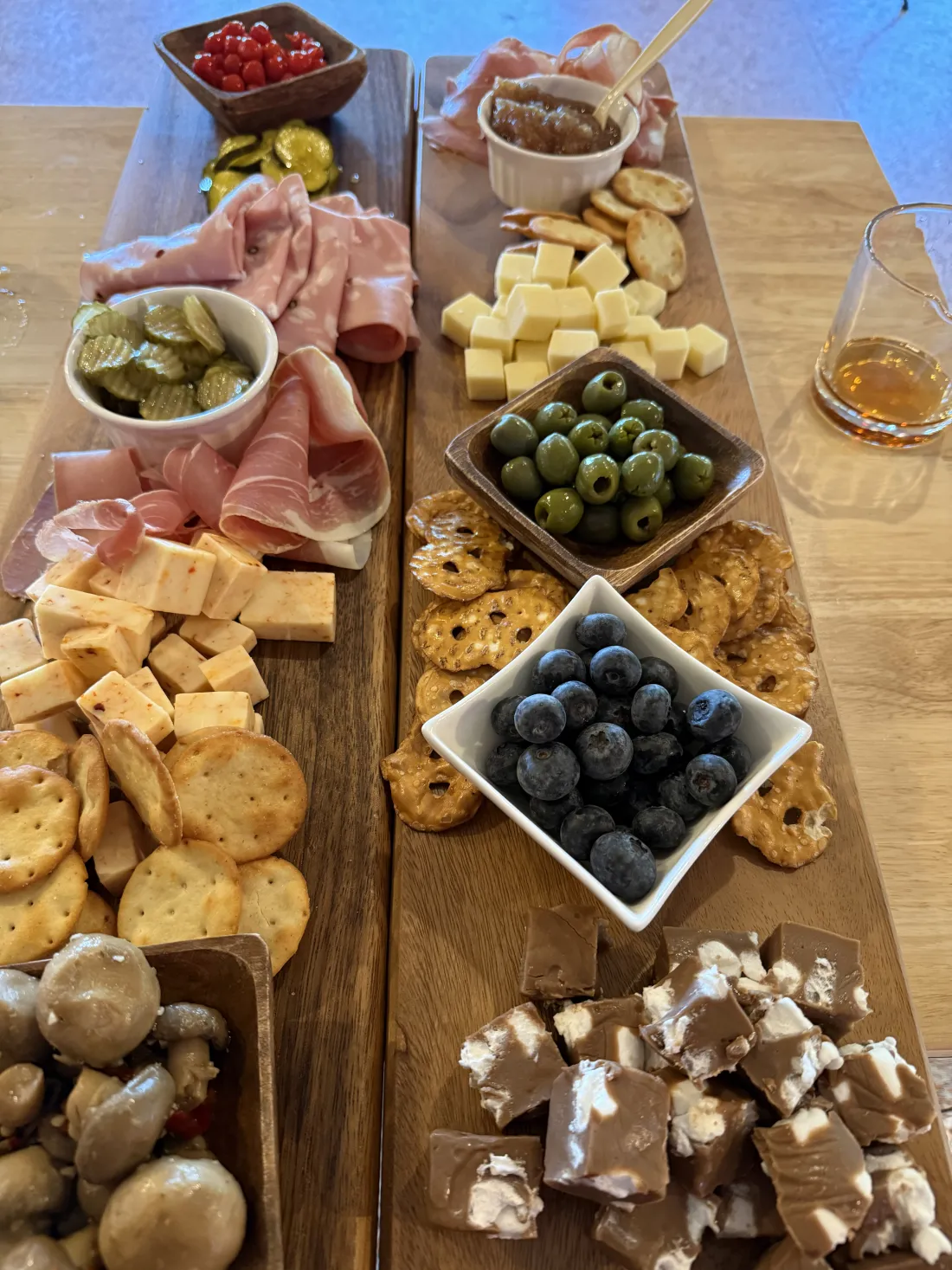 A long charcuterie spread with berries and cheeses