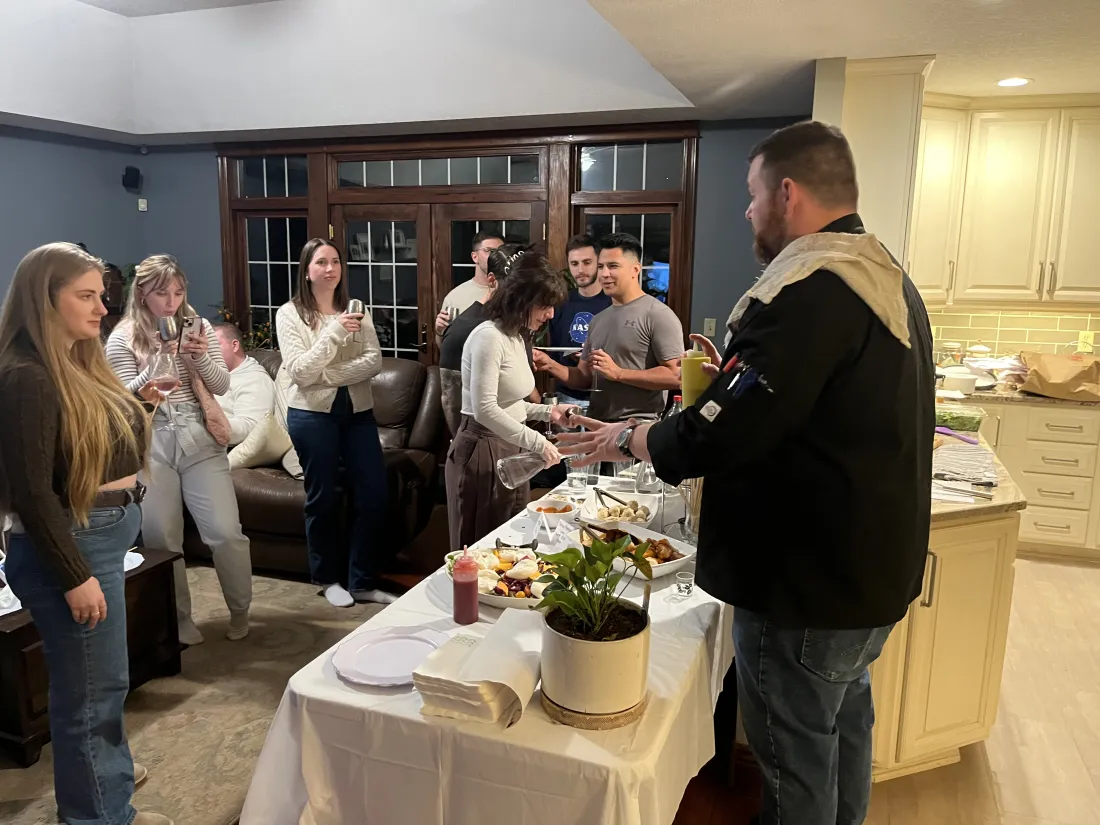 Chef Michael serving guests at a dinner party
