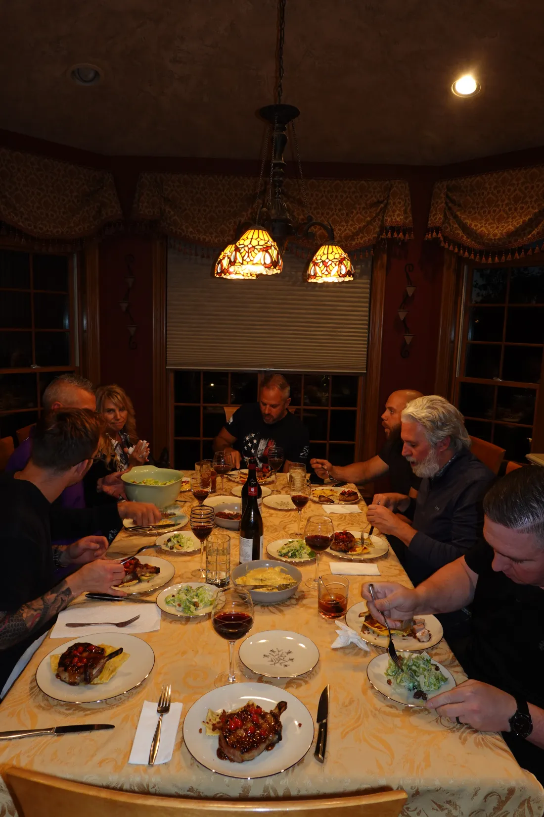 Guests at a candlelit dinner table