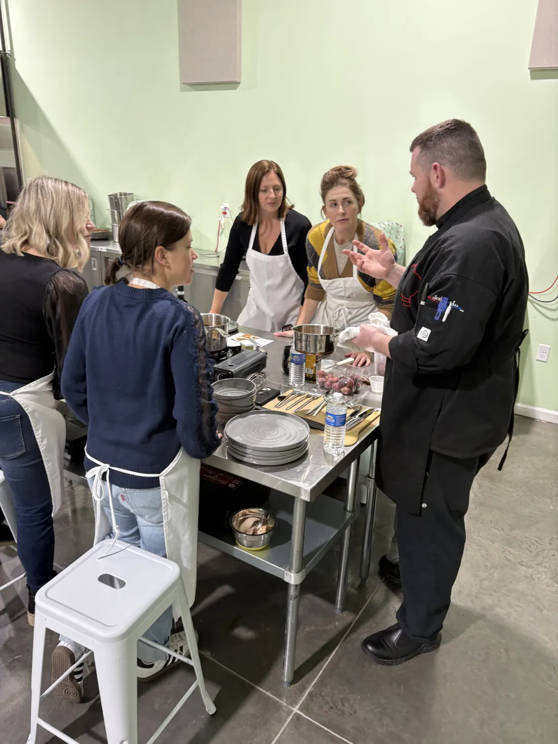 A group cooking together at a kitchen counter