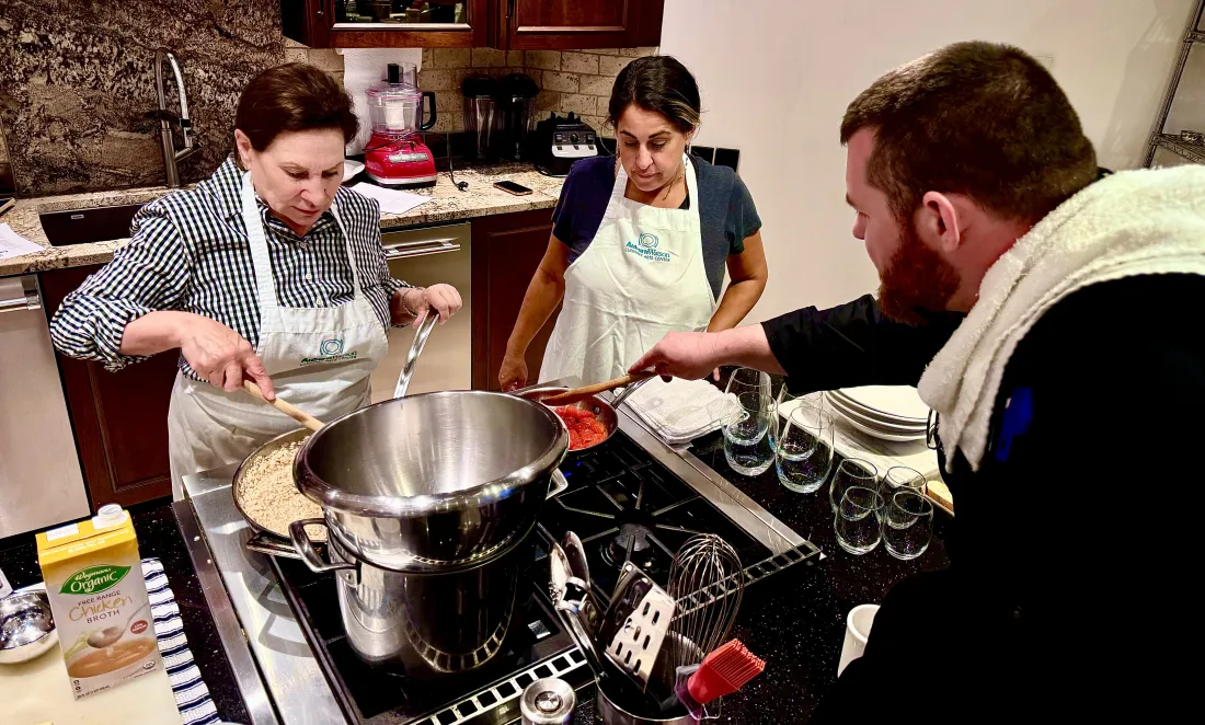 Students cooking at the stove with Chef Michael