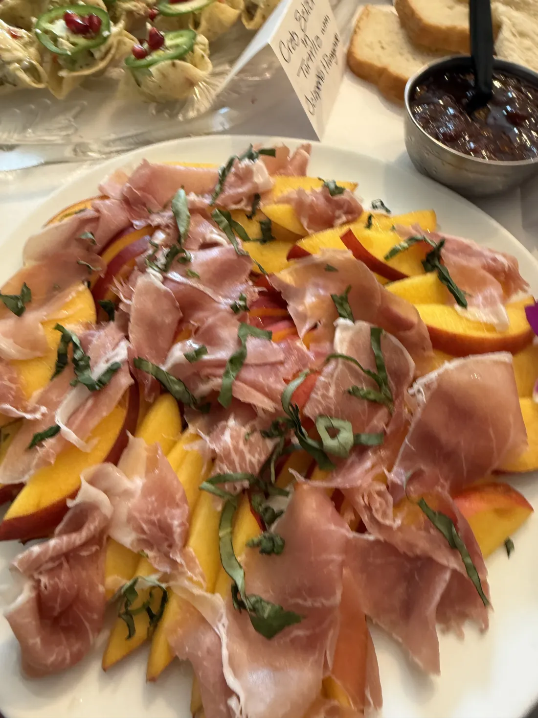 Prosciutto draped over fresh melon and mango